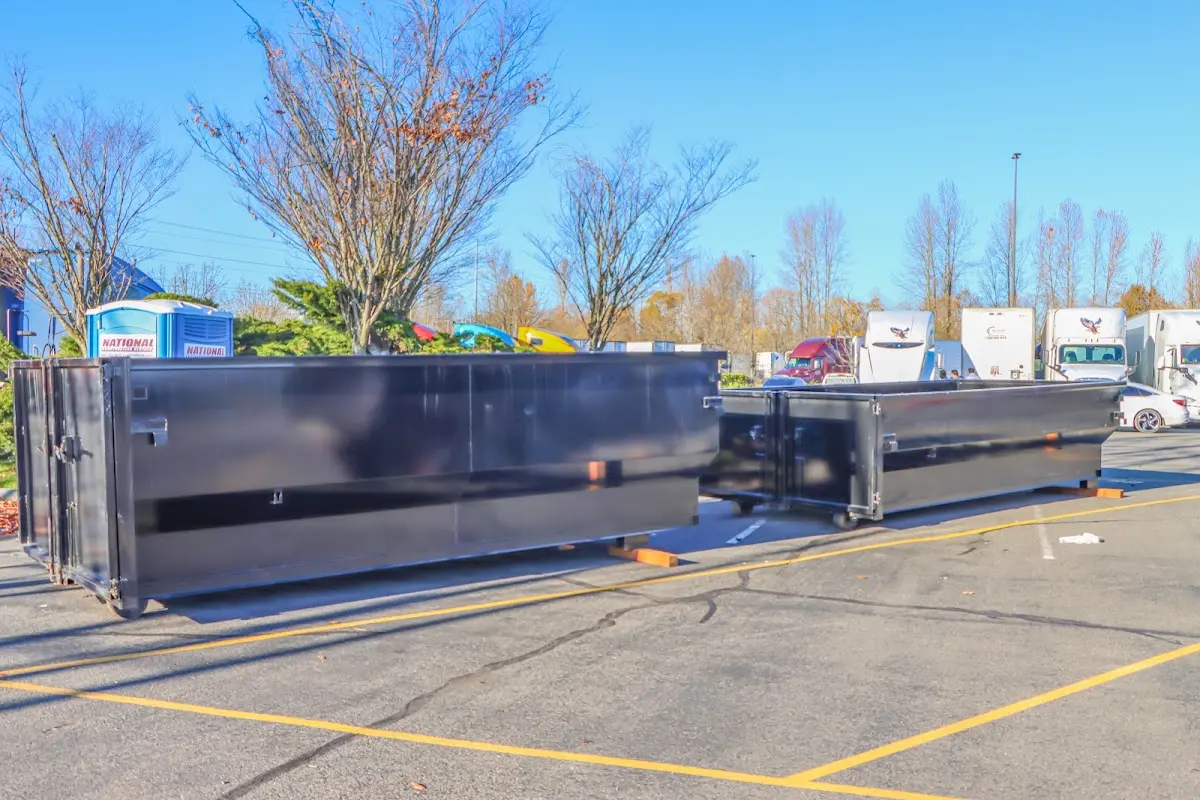 Professional dumpster rental service with roll-off container on residential driveway in Holland